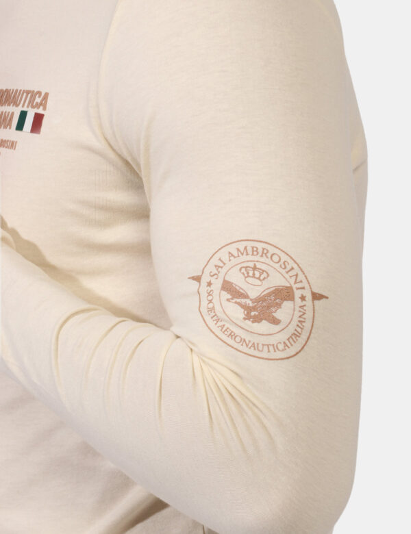 T-shirt Aeronautica Italiana Beige - T-shirt a maniche lunghe su base beige con stampa logo brand in tinta ad altezza cuore.