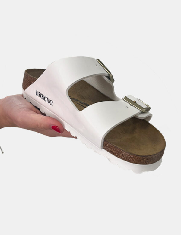 Sandali Birkenstock Bianco - Sandali modello Arizona con doppio cinturino regolabile in tinta bianca lucida. La calzata è co