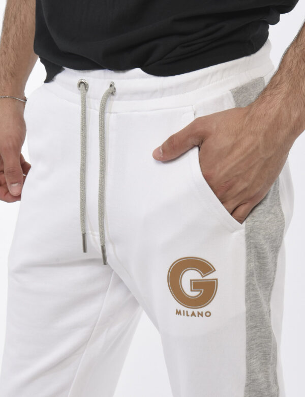 Pantaloni Gazzarrini Bianco - Pantaloni da tuta in total bianco con bande laterali grigie. Presenti tasche a taglio trasvers