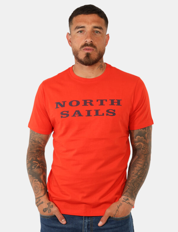 T-shirt North Sails Arancione - T-shirt classica su base arancione con stampa brand in blu. La vestibilità è morbida e regol